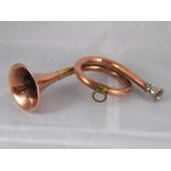 A copper hunting horn with brass mounts and plated mouthpiece.