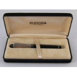 A boxed Aurora fountain pen with silver cap.