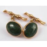 A pair of yellow metal (tests 14 carat gold) jade cufflinks of bamboo design,