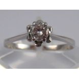 A white metal (tests 18 carat gold) diamond solitaire ring,