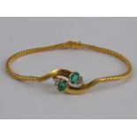 A yellow metal (tests 18 carat gold) emerald and diamond bracelet, emeralds approx 5.