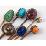 A collection of seven fine antique stick pins, five with Austro - Hungarian gold dog's head mark,