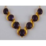 A yellow metal (tests 18 carat gold) amethyst necklace,