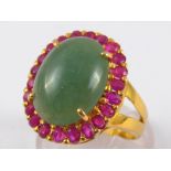 A yellow metal (tests 18 carat gold) cabochon jade and ruby ring, jade approx.