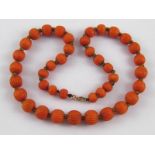 A graduated carved coral bead necklace, approx. 41cm long, beads between approx. 11mm - 7.