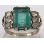 A white metal (tests 18 carat gold and platinum) emerald and diamond Art Deco ring,