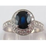 An 18 carat white gold sapphire and diamond ring, sapphire approx. 7.7 x 6.2mm, ring size M, 4.