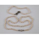 A cultured pearl necklace with a white metal (tests 14 carat gold) clasp, pearls approx 3.