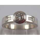 A platinum round brilliant and baguette cut diamond ring, size M, 6.8 gms.