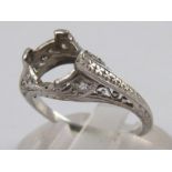 A vintage white metal (tests platinum) diamond set ring mount, lacking principal stone, size J, 2.