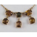 A yellow metal (tests 9 carat gold) tourmaline necklace, approx. 44cm long, drop approx. 2cm, 8.