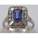 A white metal (tests 18 carat gold) tanzanite, baguette and round brilliant cut diamond ring,