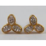 A pair of 18 carat gold three stone diamond ear studs,