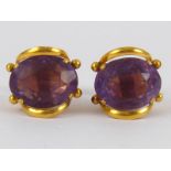 A pair of yellow metal (tests 18 carat gold) amethyst earrings, amethysts approx 13 x 10mm,