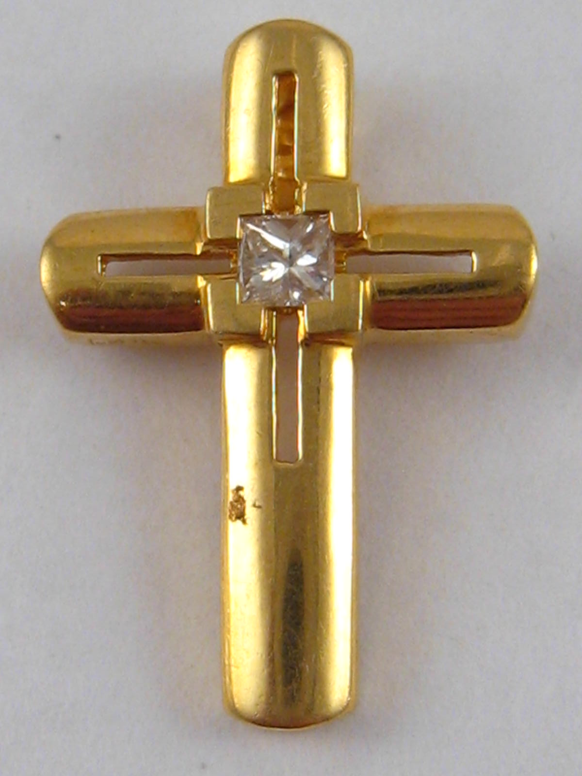 A yellow metal (tests 18 carat gold) princess cut diamond set cross pendant, approx. 2 x 1.5cm, 2.