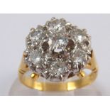 A yellow metal (tests 18 carat gold) diamond cluster ring, total estimated diamond content approx 0.