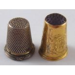 A Swedish 18ct. gold thimble with hardstone end, hallmarked 1861, and a 800 standard silver thimble.