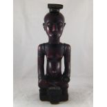 A Lubu tribe, Congo, carving in very dense African hardwood of a seated woman. ht.43cm.