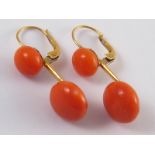 A pair of yellow metal (tests 18 carat gold) coral drop earrings, larger corals approx 12 - 12.