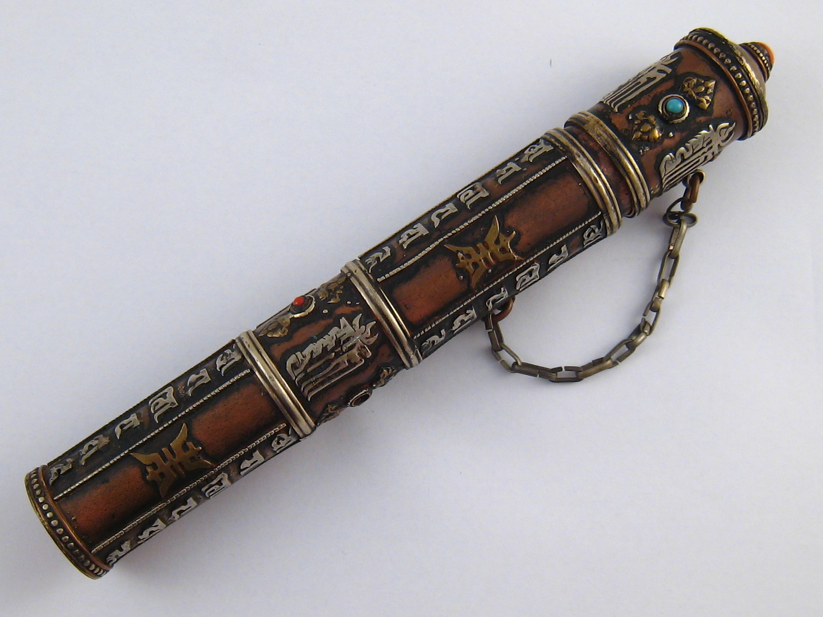 An Eastern brass scroll holder, possibly Tibetan,