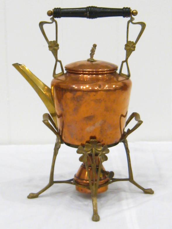 A copper and brass kettle on stand complete with burner. Ht. 36cm.