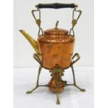A copper and brass kettle on stand complete with burner. Ht. 36cm.