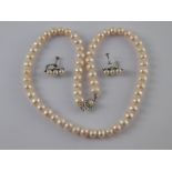 A mixed lot comprising a freshwater cultured pearl necklace with a white metal (tests 18 carat