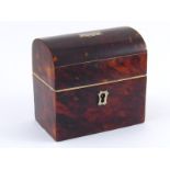 A tortoiseshell jewellery box with domed top , lock and key , with vacant cartouche.