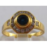 A yellow metal (tests 18 carat gold) sapphire and diamond ring, sapphire approx 4mm diameter,