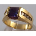 A yellow metal (tests 14 carat gold) synthetic colour change alexandrite and diamond ring, size M,