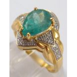 A yellow metal (tests 18 carat gold) pear shape emerald and diamond ring,