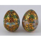 A pair of cloisonne enamelled gilt metal eggs., length 6cm.