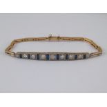 A yellow and white metal (tests 18 carat gold and platinum) sapphire and diamond bracelet,