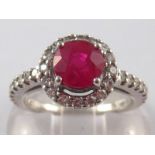 A white metal (tests 18 carat gold) ruby and diamond ring , the ruby measuring approx 6.