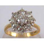 A yellow metal (tests 18 carat gold) diamond cluster ring, estimated total diamond content approx 1.