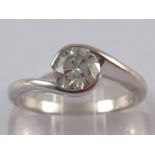 An 18 carat white gold crossover diamond solitaire ring,