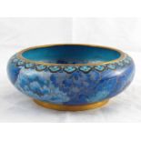 A brass bowl cloisonne enamelled with butterflies and flowers in shades of blue. 15cm. diameter.