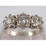 An 18 carat white gold three stone diamond ring, estimated total diamond content approx 0.