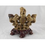 A Chinese hardstone carving with temple lions guarding a censer pot with lion finial cover. Ht.