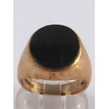 A 9 carat gold onyx signet ring, onyx approx 16 x 14mm, ring size S, 9 gms.