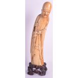 A 17TH CENTURY CHINESE CARVED IVORY FIGURE OF AN IMMORTAL Ming Dynasty, modelled with one hand