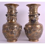 A PAIR OF LATE 19TH CENTURY CHINESE BRONZE VASES bearing Ming marks to base, overlaid in relief with