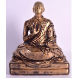 A VERY RARE SINO TIBETAN GILT BRONZE FIGURE OF A LAMA probably 18th century, modelled seated with