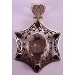 A SILVER AND ROCK CRYSTAL STAR SHAPED PENDANT inset with six facetted red garnets. 2.25ins wide.