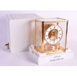 A FINE JAEGER-LECOULTRE CASED ATMOS CLOCK No.661216 contained within a fitted white leather type