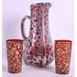 A LOVELY EARLY 20TH CENTURY BOHEMIAN HALLMARKED SILVER OVERLAID RUBY GLASS JUG together with two