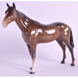 A BESWICK FIGURE OF A STANDING BROWN HORSE. 9ins wide.