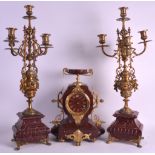 A 19TH CENTURY FRENCH RED VEINED MARBLE CLOCK GARNITURE with twin handled classical urn finial,