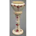 AN EDWARDIAN CONTINENTAL POTTERY JARDINIÈRE AND PEDESTAL STAND decorated with extensive foliage