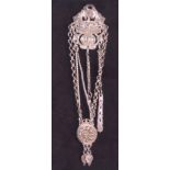 AN UNUSUAL MIDDLE EASTERN WHITE METAL CHATELAINE  formed as a basket of flowers with hanging